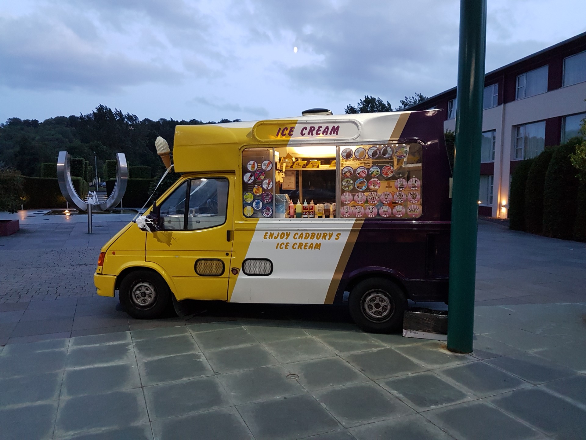 Lollie Dollies ice cream van parked and serving in a peaceful outdoor setting with a full evening menu displayed